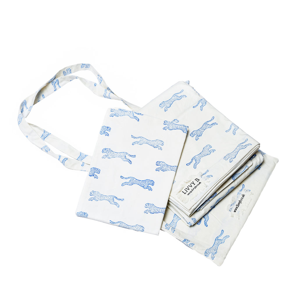 A bedding set with a cheetah print design, including a duvet cover and pillowcases, laid out on a white background.